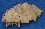Triangular decorated bone comb from Sutton Courtenay (AN1926.81)